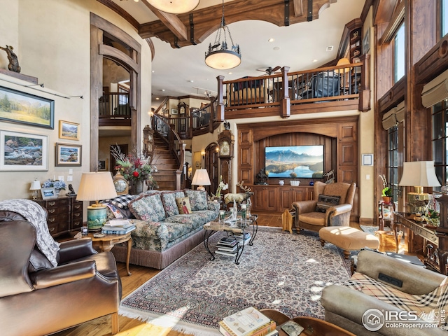 living room featuring a towering ceiling and wood-type flooring