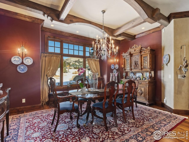 dining space with dark hardwood / wood-style flooring, a notable chandelier, and beam ceiling