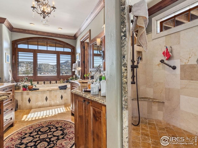 bathroom featuring crown molding, shower with separate bathtub, vanity, and a chandelier