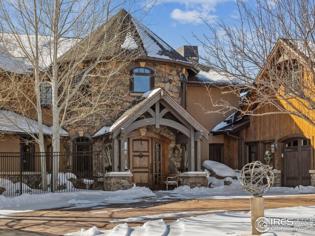 view of snow covered property entrance