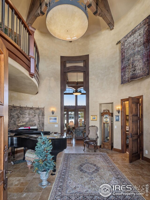 miscellaneous room with a towering ceiling