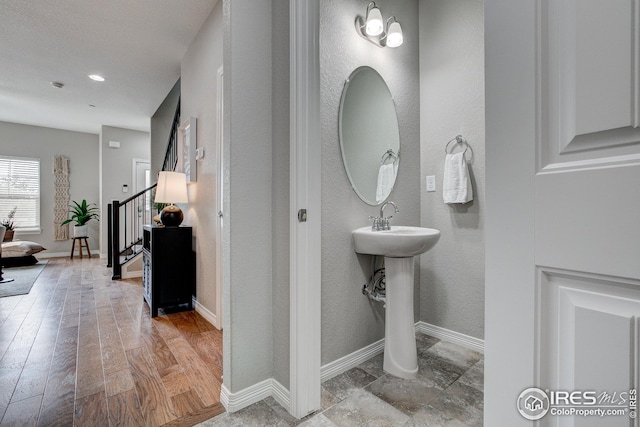 bathroom with hardwood / wood-style flooring and a chandelier