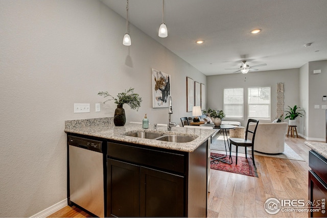 kitchen with dark brown cabinets, sink, stainless steel dishwasher, and light hardwood / wood-style floors