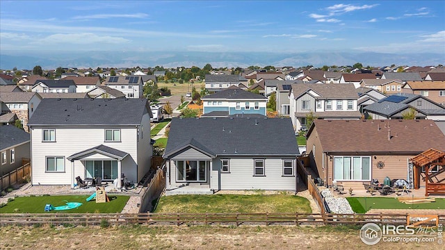 rear view of property with a patio, a fenced backyard, and a residential view