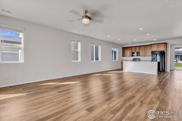 unfurnished living room with visible vents, recessed lighting, ceiling fan, and a wealth of natural light