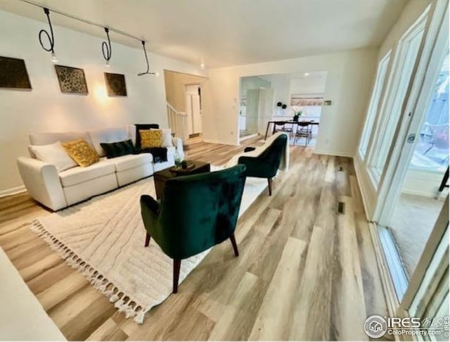 living room featuring baseboards and wood finished floors