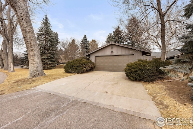 view of side of home featuring driveway and a garage