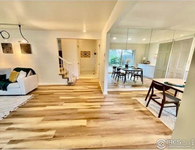 living room with stairway, baseboards, wood finished floors, and recessed lighting