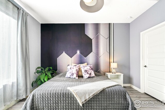 bedroom with hardwood / wood-style floors