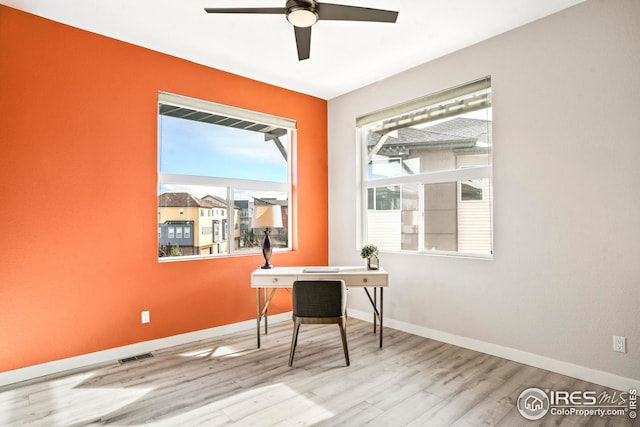office space with light hardwood / wood-style flooring and ceiling fan