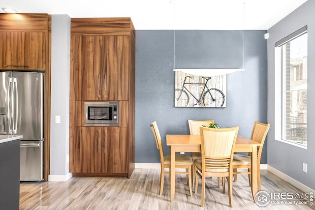 dining space featuring light wood-type flooring