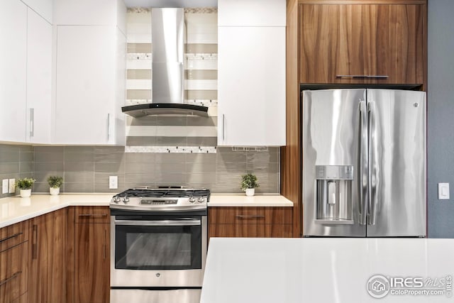 kitchen featuring stainless steel appliances, white cabinetry, and exhaust hood