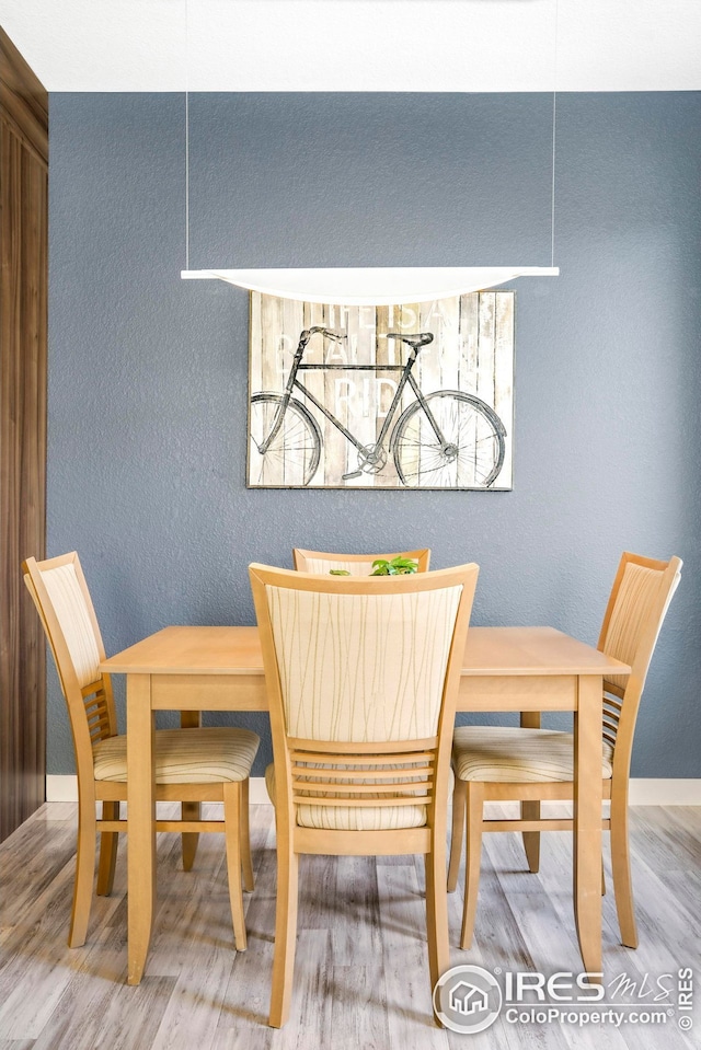 dining space with hardwood / wood-style flooring