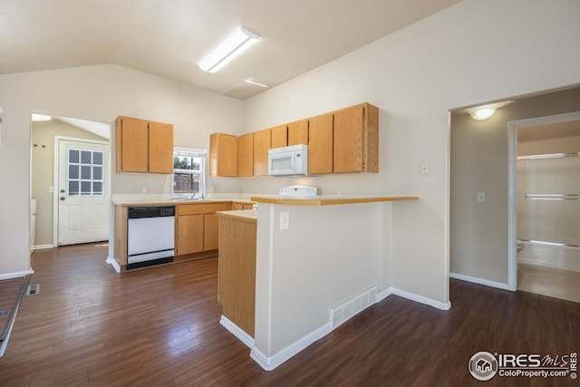 kitchen with dark hardwood / wood-style flooring, lofted ceiling, white appliances, and kitchen peninsula