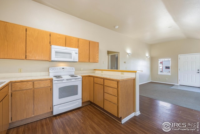 kitchen featuring dark hardwood / wood-style floors, white appliances, vaulted ceiling, and kitchen peninsula