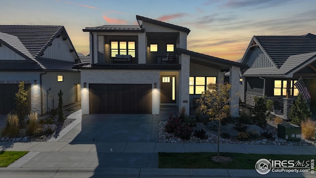 modern home with driveway, board and batten siding, and an attached garage