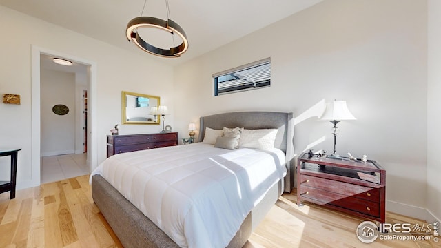 bedroom with light wood-style floors and baseboards