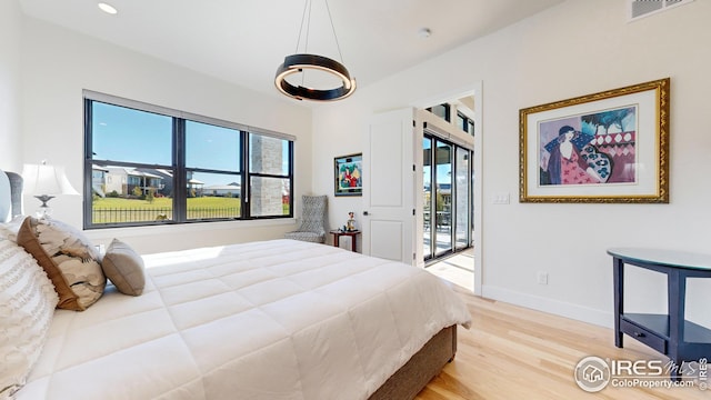 bedroom featuring recessed lighting, wood finished floors, visible vents, baseboards, and access to outside