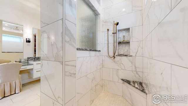 full bathroom featuring a walk in shower and vanity