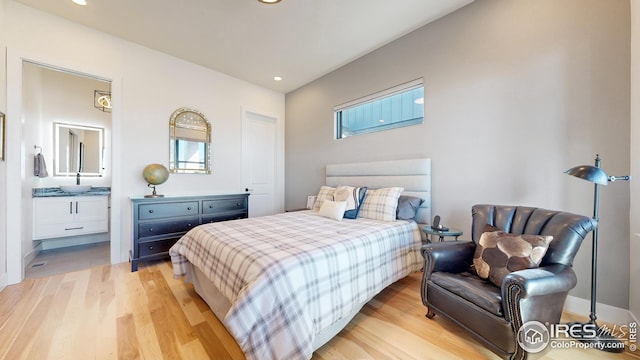 bedroom featuring recessed lighting, baseboards, light wood finished floors, and ensuite bathroom