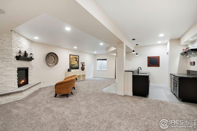 interior space featuring recessed lighting, light colored carpet, a fireplace, and baseboards