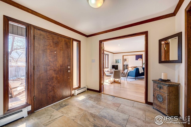 foyer entrance with crown molding and a baseboard heating unit