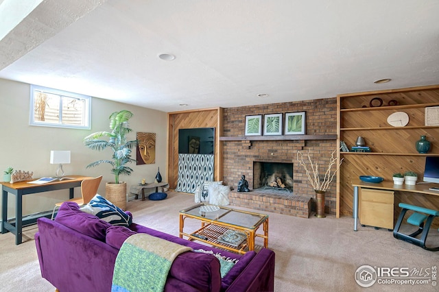 carpeted living room with a brick fireplace and wooden walls