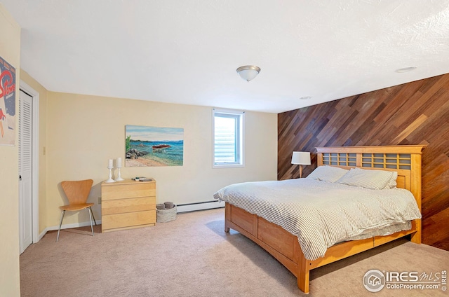 carpeted bedroom featuring wooden walls and a baseboard heating unit