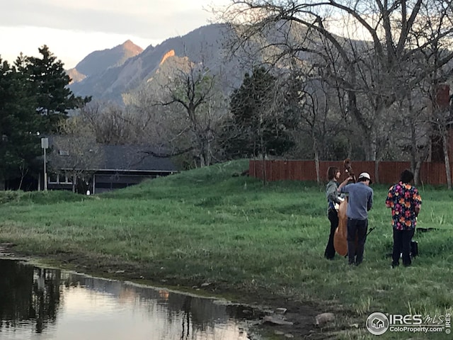 surrounding community with a water and mountain view