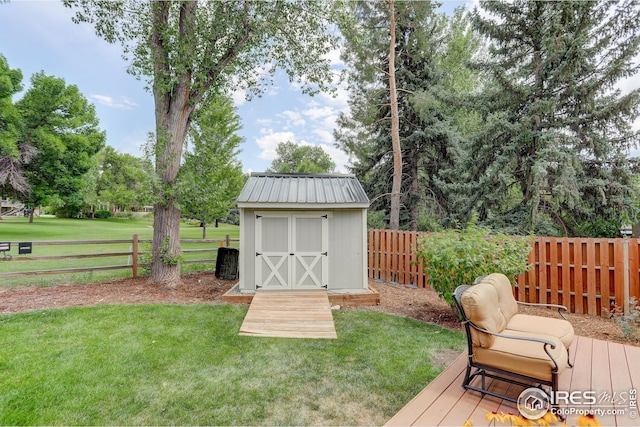 deck featuring a yard and a storage shed