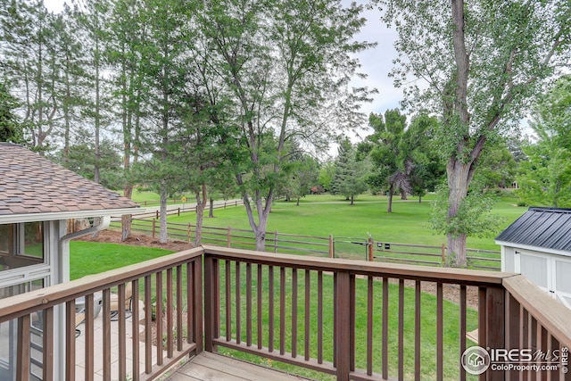 wooden deck featuring a yard