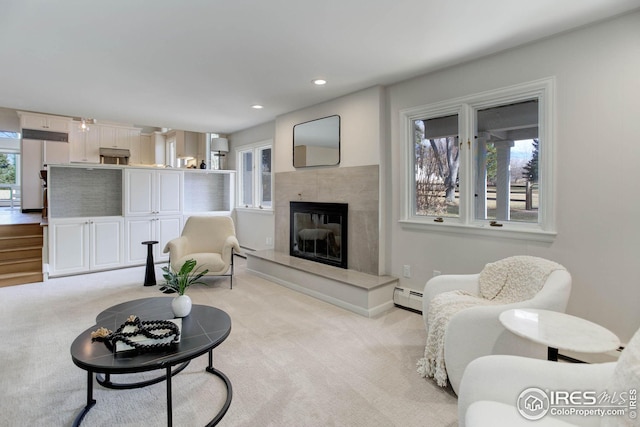 carpeted living room featuring a fireplace and baseboard heating