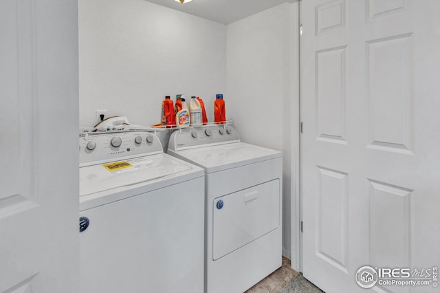 laundry area with washing machine and clothes dryer and laundry area