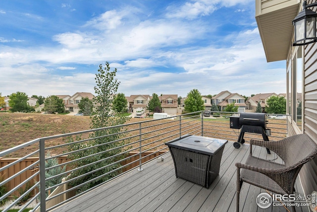 deck with a residential view and a grill