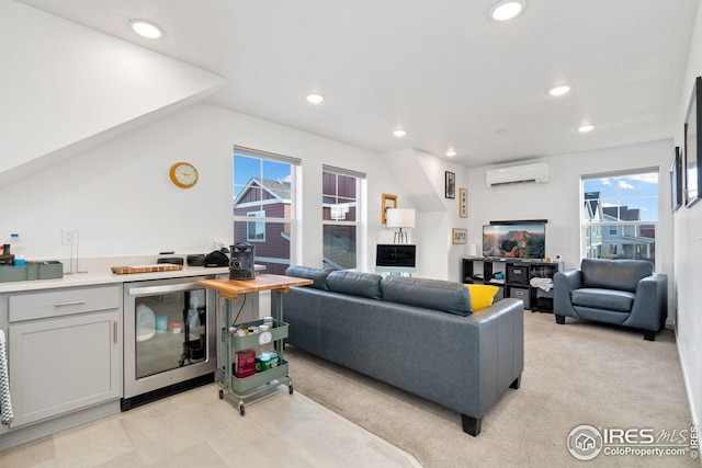 living room featuring wine cooler, a wall mounted AC, and a wealth of natural light