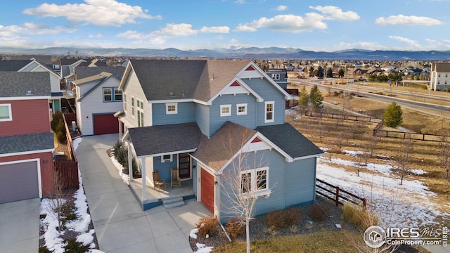 view of front of home with a garage and a mountain view