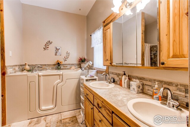 420 E County Road 10, Berthoud, CO 80513 - full bath featuring double vanity, a sink, and a garden tub