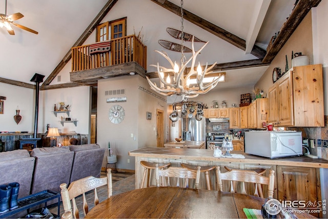 420 E County Road 10, Berthoud, CO 80513 - kitchen with stainless steel range oven, ceiling fan with notable chandelier, under cabinet range hood, tile countertops, and white microwave