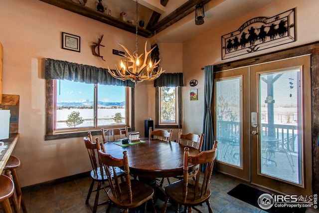 420 E County Road 10, Berthoud, CO 80513 - dining space featuring baseboards, dark tile patterned floors, french doors, and an inviting chandelier