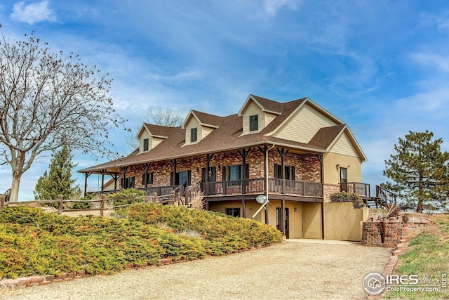420 E County Road 10, Berthoud, CO 80513 - view of front of property with brick siding, driveway, and stairway