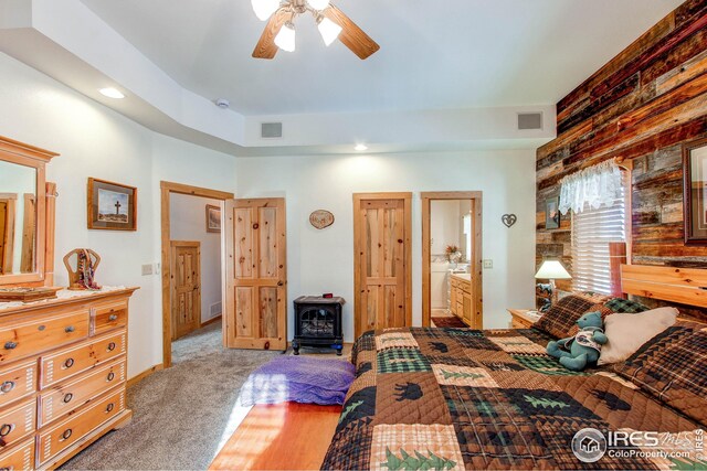 420 E County Road 10, Berthoud, CO 80513 - bedroom featuring visible vents, ceiling fan, carpet floors, and a wood stove