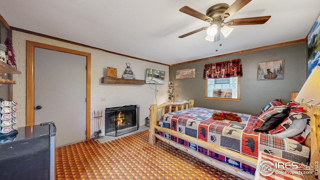 bedroom featuring crown molding, ceiling fan, a fireplace, and carpet