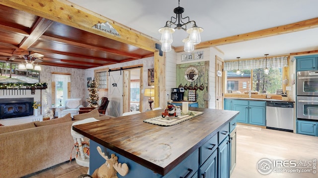 interior space featuring a barn door, beam ceiling, and light hardwood / wood-style flooring