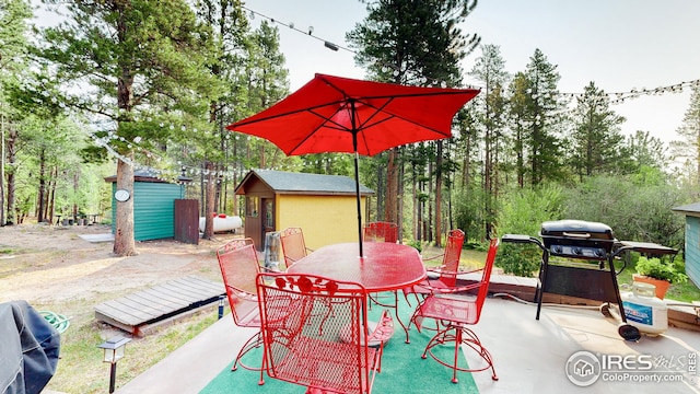 view of patio featuring grilling area and a storage shed