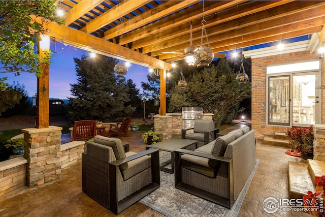 patio terrace at dusk featuring an outdoor living space, a pergola, a grill, and exterior kitchen