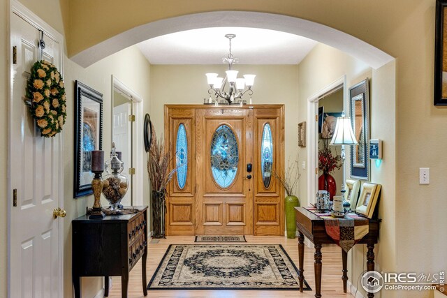 entrance foyer featuring an inviting chandelier and light wood-type flooring