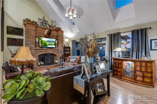 living room featuring lofted ceiling and light hardwood / wood-style floors