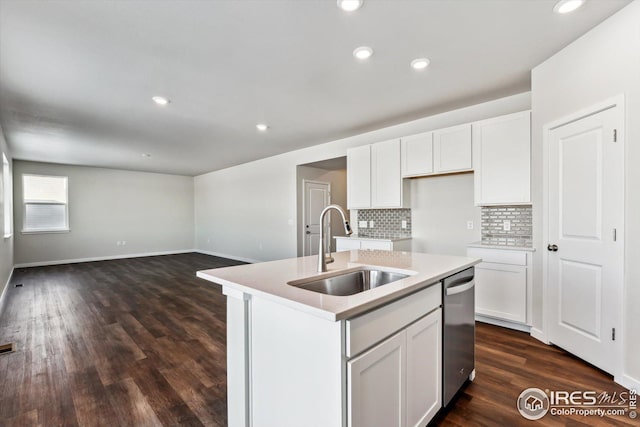 kitchen with white cabinetry, stainless steel dishwasher, an island with sink, and sink