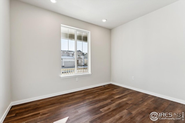 empty room featuring dark wood-type flooring