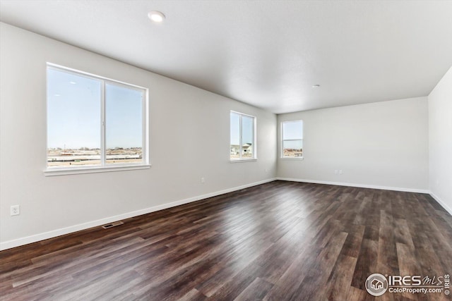 unfurnished room with dark hardwood / wood-style floors